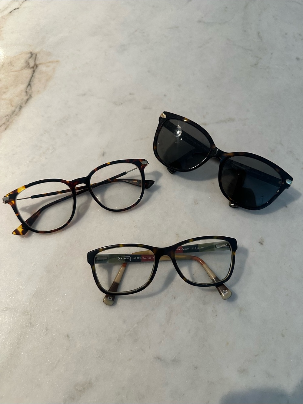 Three sets of glasses with prescription lenses